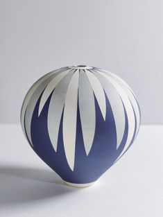 a blue and white vase sitting on top of a table