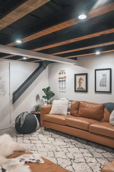 a living room with couches and pictures on the wall