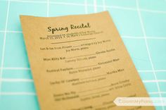 a close up of a paper menu on a blue table with white and black checkered cloth