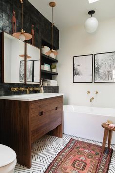 a bathroom with a rug, sink and bathtub