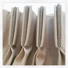 three zippers are attached to the side of a beige curtain with two sides facing each other