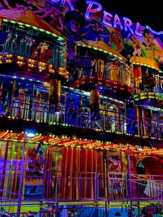 an illuminated building with lots of lights on it's sides and balconies