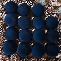 several blue round cushions surrounded by pine cones