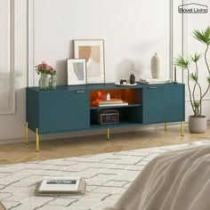 a living room with a bed and a blue cabinet in the corner next to a plant