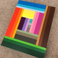 a piece of art that looks like it has been made out of different colored squares