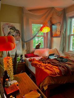 a bed room with a neatly made bed next to a window and two lamps hanging from the ceiling