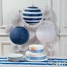 a table topped with blue and white paper decorations