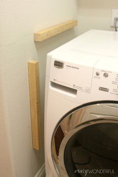 a washer and dryer in a small room with no door on the wall