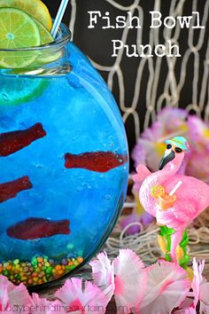 a fish bowl punch is in a vase with flowers around it and a flamingo figurine