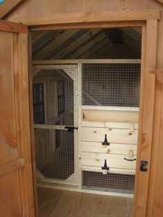 the inside of a chicken coop with its doors open