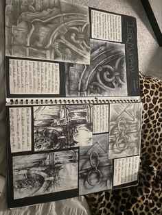 an open notebook with drawings on it and some writing in the pages next to a leopard print pillow