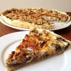 a slice of pizza sitting on top of a white plate next to a pie pan