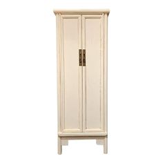 a tall white cabinet with two doors