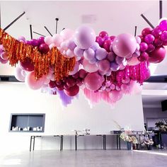 balloons and streamers are hanging from the ceiling