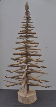 a wooden christmas tree made out of driftwood