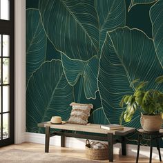 a living room with green wallpaper and a bench in front of the window that has a plant on it