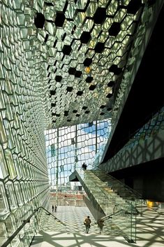 the inside of a building with glass walls and stairs