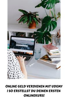 a person sitting at a desk with a laptop computer in front of them and plants on the wall