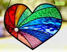 a stained glass heart hanging from a chain