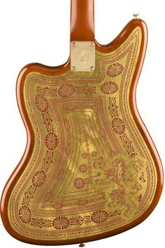 an old guitar with gold paint on the body and back side, sitting in front of a white background