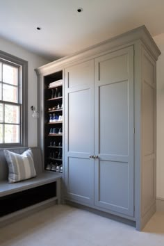 a large white closet sitting next to a window