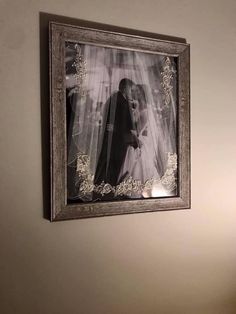 a framed photo hanging on the wall above a toilet