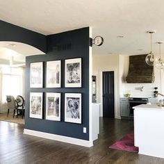 a kitchen and dining room with pictures on the wall