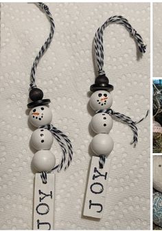 two snowmen are hanging from the side of a christmas ornament on a bed