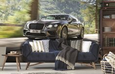 a living room with a blue couch and a black car on top of the sofa