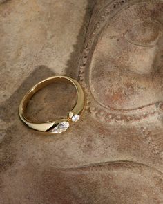 a close up of a wedding ring on a rock