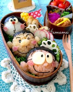 some food that is sitting in a bowl on a blue table cloth with utensils