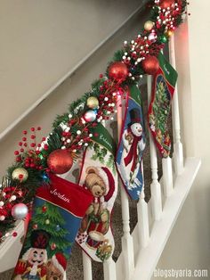 christmas stockings are hanging on the banister