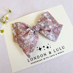 "Liberty of London x HK fabric imported from Japan featuring dusty pink floral print.  Comes in our twirl style bow on a lead free alligator hair clip clip, a soft nylon baby headband or our hard bow headband. Hard knot headband fits toddlers, kids and adults.  Small size bow measures 3.75\" Medium size bow measures 4.50\" Large size bow measures 5.50\" Top knot measures 3.0\" Hard covered headband has a large sized bow.  Handmade with love and magic in Southern California." Cute Pink Summer Bow, Pink Hair Bow Accessories For Spring, Whimsical Pink Hair Accessories With Handmade Flowers, Cute Satin Bow For Spring, Pink Bow Gift For Spring, Pink Satin Bow Hair Accessories For Spring, Spring Pink Satin Bow Hair Accessories, Spring Pink Hair Accessories With Satin Bow, Spring Pink Hair Accessories With Bow