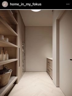 an empty walk in closet with wooden shelves