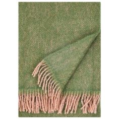 a green and beige blanket with fringes