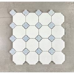 a white tile with blue flowers on it