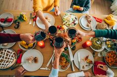 people sitting at a table with food and drinks in front of them, top view