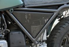 the front end of a motorcycle with black mesh