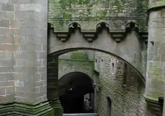 an old stone tunnel with a clock on the wall