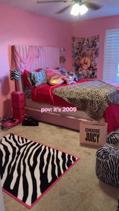 a bedroom decorated in pink and zebra print