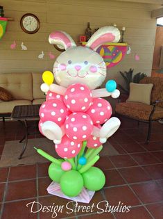 a balloon sculpture in the shape of a bunny with balloons on it's back