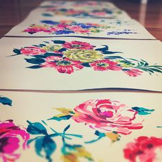 three flowered cards are lined up on the floor