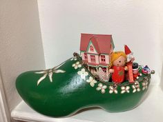 This beautiful Dutch shoe centerpiece is filled with vintage and nostalgic Christmas piece.  A collage of Christmas ornaments makes it a one of a kind piece. Makes a great hostess gift. It is approximately 12 1/2" long 6" wide and 7" high Dutch Christmas, Christmas Boutique, Nostalgic Christmas, Naples Fl, A Collage, Work Ideas, How To Make Ornaments, Hostess Gifts, Naples