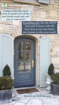 a blue front door with two planters on either side and an email message above it