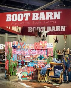 a booth at a boot barn with lots of items for sale on the floor and in front of it