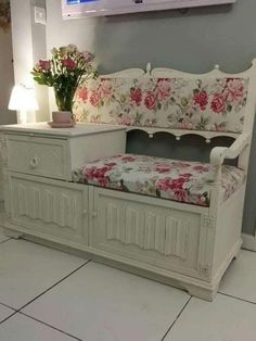 a white bench with pink flowers on it