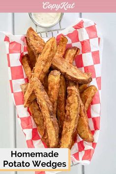 homemade potato wedges on a red and white checkered paper