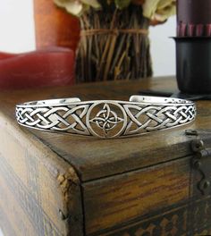 Witch's Knot Open Bangle Cuff Bracelet with Celtic Knots | Woot & Hammy Symbolic Round Adjustable Cuff Bracelet, Adjustable Symbolic Sterling Silver Bangle Bracelet, Adjustable Symbolic Sterling Silver Cuff Bracelet, Silver Symbolic Metal Cuff Bracelet, Witch's Knot, Finding Feathers, Witch's Cottage, Celtic Knot Bracelet, Round Border