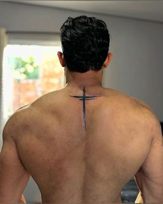 a man with a cross tattoo on his back