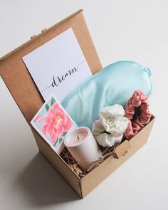 an open box containing soaps, candles and a note with the word dream written on it